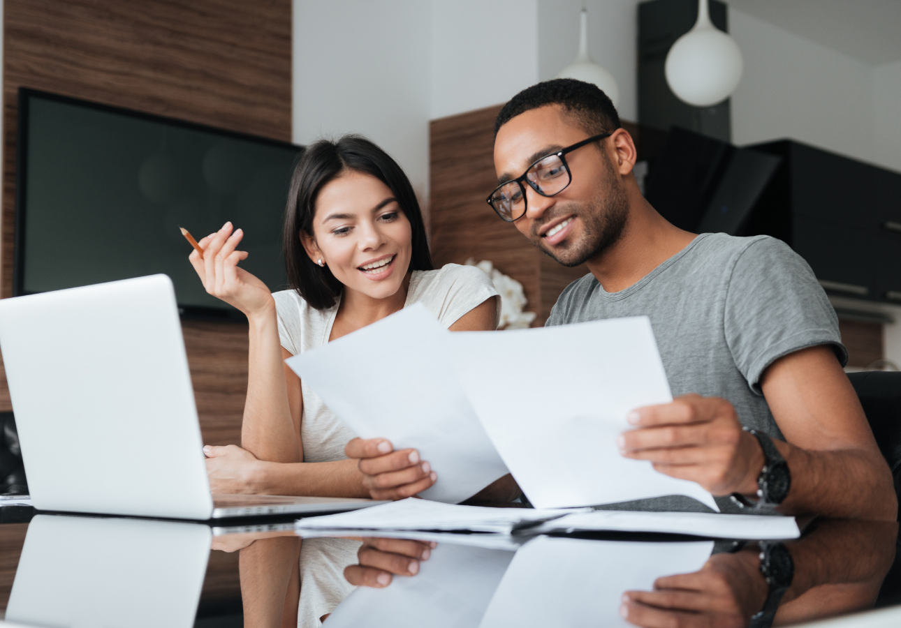 Canadian couple reviewing financial documents together, discussing RRSP and TFSA strategy