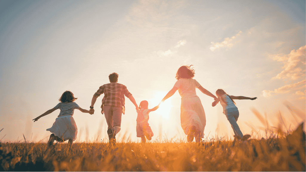 Family walking together in sunset light, symbolizing financial freedom and saving for the future