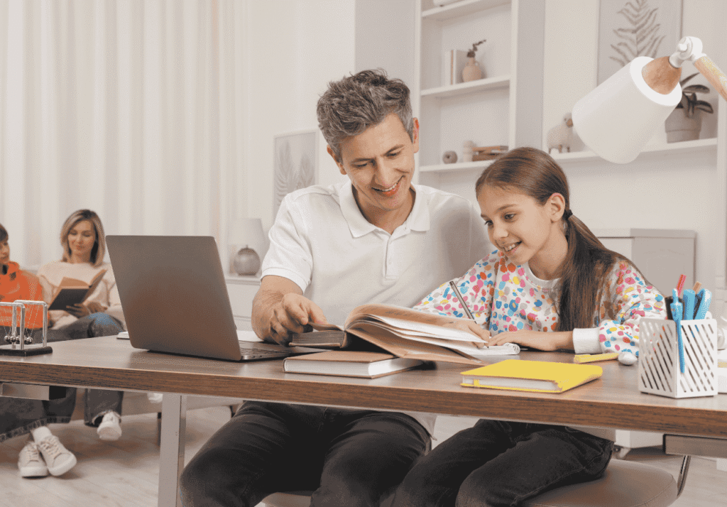 Parent helping a child study at home with a laptop on the table, symbolizing Canadian families planning and saving for education with an RESP.