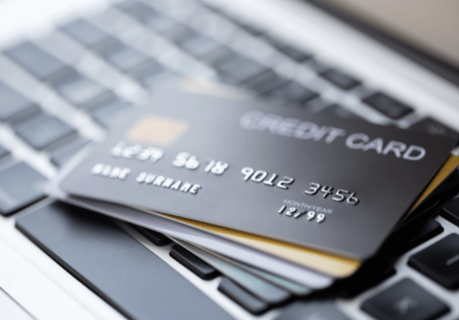 Close-up of a credit card placed on a laptop keyboard.
