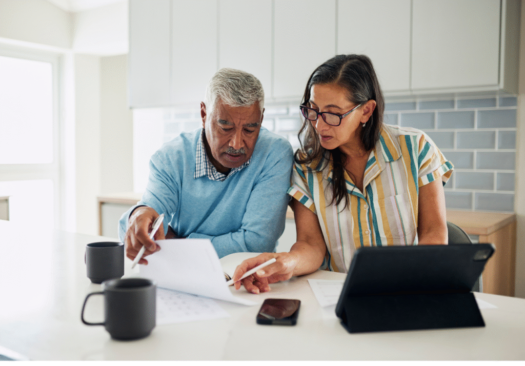 Canadian couple reviewing financial documents together while discussing TFSA planning in January