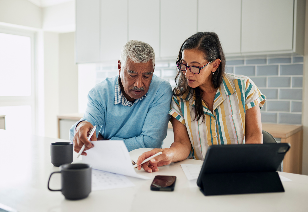 Canadian couple reviewing financial documents together while discussing TFSA planning in January