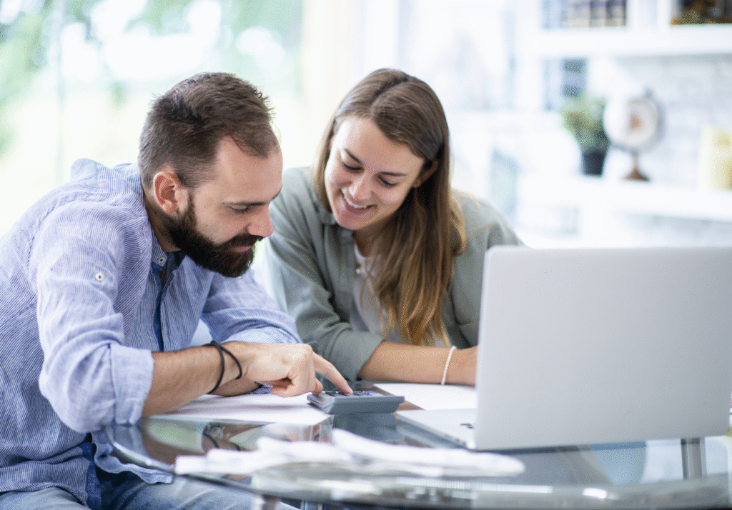 emergency-fund-canada-couple-reviewing-finances Couple reviewing household finances while discussing emergency savings in Canada