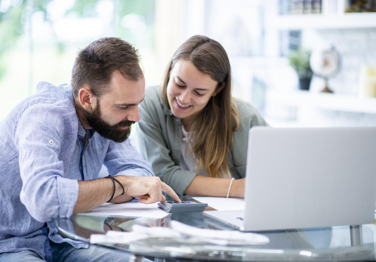 Canadian couple reviewing emergency fund savings at kitchen table