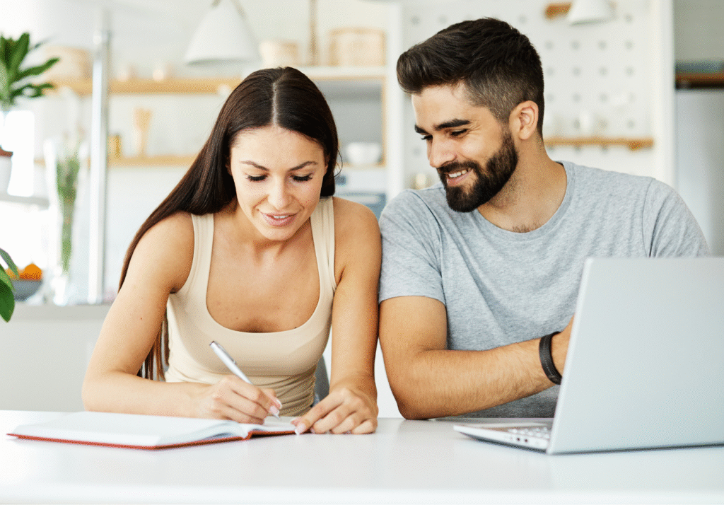 how-much-emergency-fund-do-i-need-canada-couple-budgeting Couple reviewing expenses to calculate how much emergency fund they need in Canada
