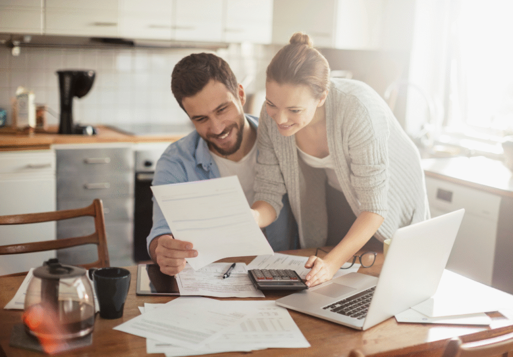 Canadian couple reviewing household finances together at a kitchen table using a simple family finance system