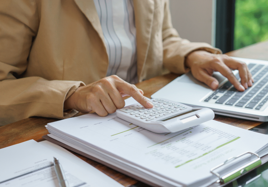 Person calculating family tax credits and expenses during Canadian tax preparation