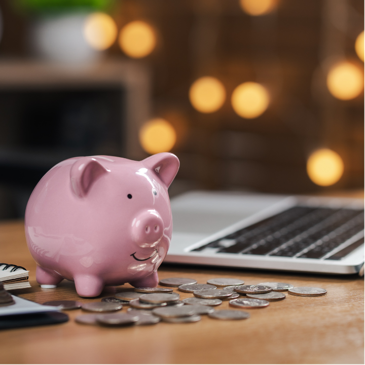A pink piggy bank with coins on a desk, representing common RRSP mistakes such as leaving savings in cash without a long-term plan.