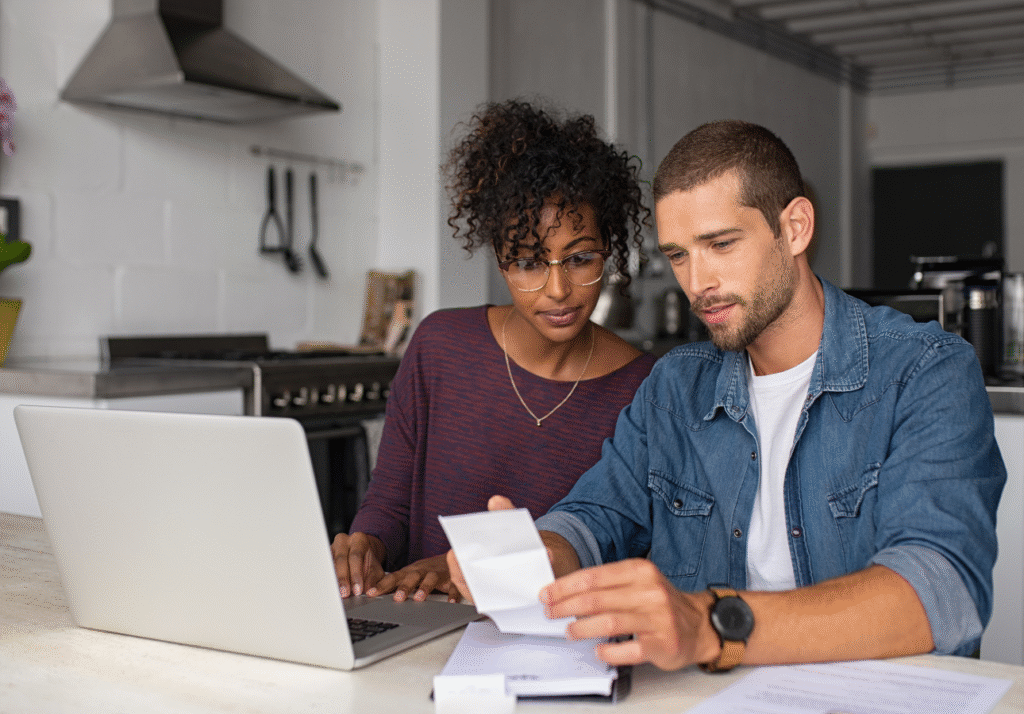 A couple reviewing household finances and deciding where to park cash safely in Canada