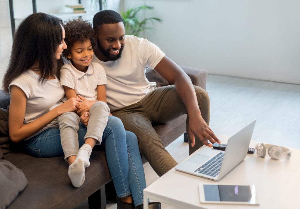 Middle income Canadian family reviewing finances together on a laptop at home
