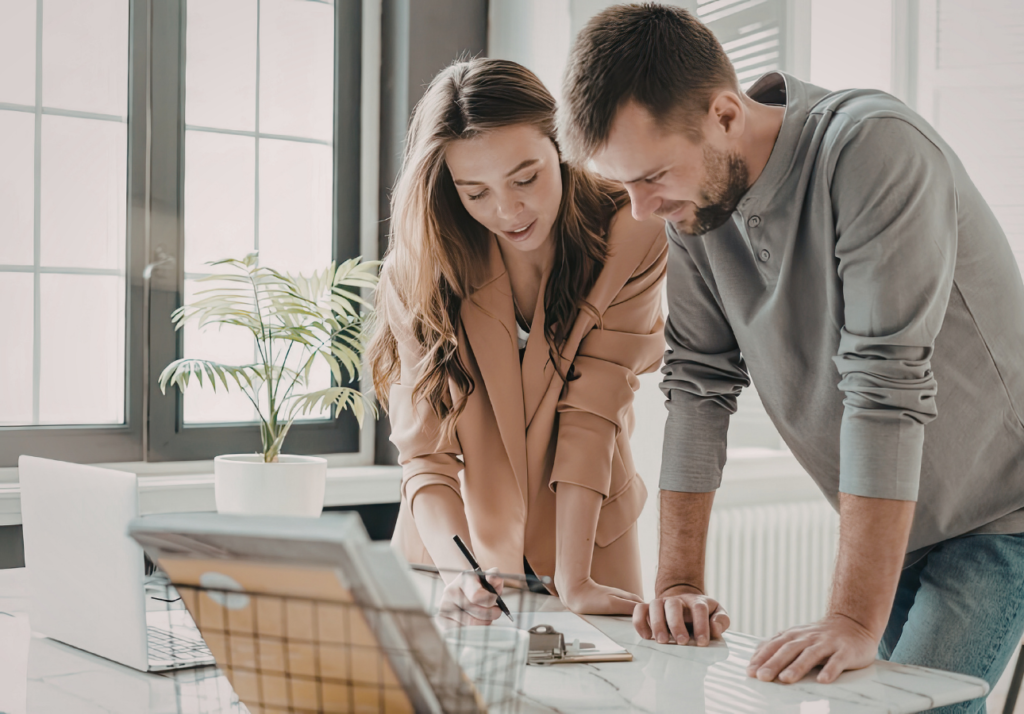 Canadian couple reviewing finances at home with laptop and documents planning long term investments and TFSA strategy