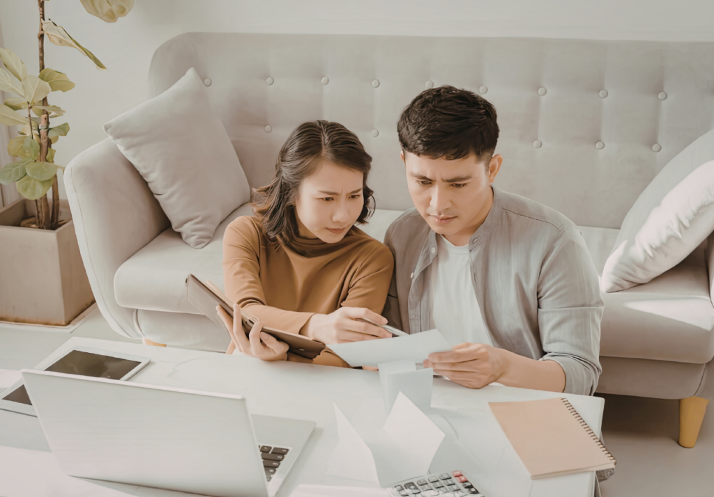 Family reviewing finances and planning monthly budget at home